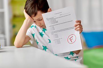 Image showing sad student boy with failed school test at home