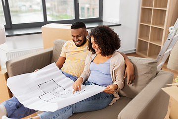 Image showing couple with boxes and blueprint moving to new home