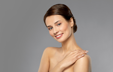 Image showing beautiful young woman touching bare shoulder