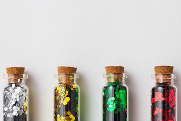 Image showing set of glitters in bottles over white background