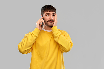 Image showing sad young man calling on smartphone