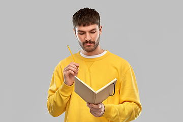 Image showing thinking man with diary and pencil