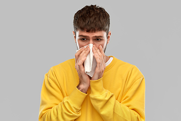 Image showing man with paper napkin blowing nose