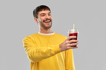 Image showing happy man with tomato juice in takeaway cup