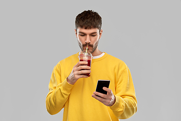 Image showing man with smartphone and tomato juice