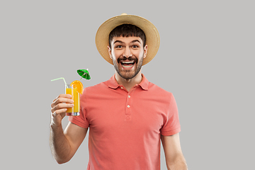 Image showing happy man in straw hat with orange juice cocktail