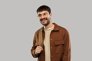 Image showing smiling young man in glasses with backpack