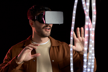 Image showing happy man in vr glasses over black background