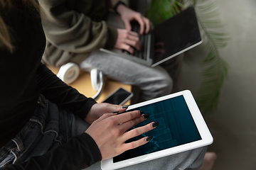 Image showing Close up of two people, couple using smartphone, laptop, smartwatch, education and business concept, communication during self-insulation