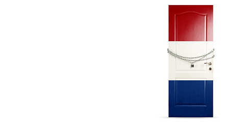 Image showing Door colored in Netherlands flag, locking with chain. Countries lockdown during coronavirus, COVID spreading