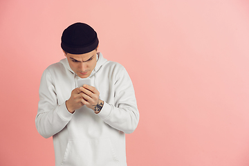 Image showing Caucasian young man\'s modern portrait on pink studio background