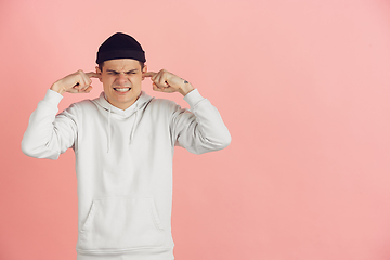 Image showing Caucasian young man\'s modern portrait on pink studio background