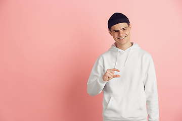 Image showing Caucasian young man\'s modern portrait on pink studio background