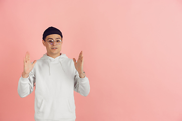 Image showing Caucasian young man\'s modern portrait on pink studio background