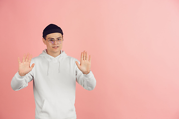 Image showing Caucasian young man\'s modern portrait on pink studio background