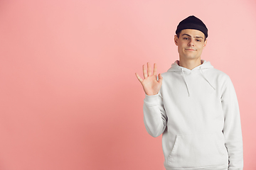 Image showing Caucasian young man\'s modern portrait on pink studio background