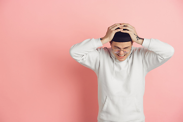 Image showing Caucasian young man\'s modern portrait on pink studio background