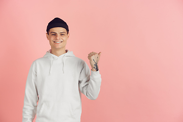 Image showing Caucasian young man\'s modern portrait on pink studio background