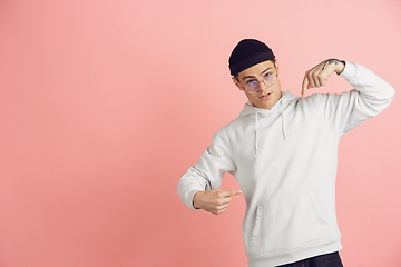 Image showing Caucasian young man\'s modern portrait on pink studio background