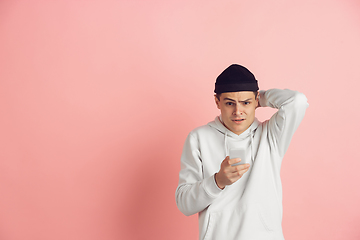 Image showing Caucasian young man\'s modern portrait on pink studio background