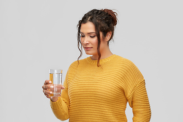 Image showing smiling young woman with water in glass