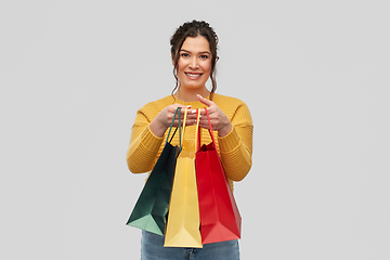 Image showing happy smiling young woman with shopping bags