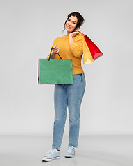 Image showing happy smiling young woman with shopping bags