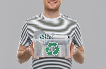 Image showing smiling young man sorting metallic waste