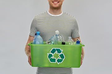 Image showing smiling young man sorting plastic waste