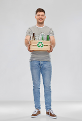 Image showing smiling young man sorting glass waste