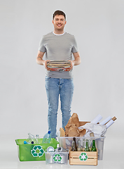 Image showing smiling man sorting paper, metal and plastic waste