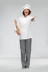 Image showing happy female chef with french bread or baguette