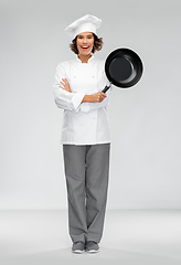 Image showing smiling female chef in toque with frying pan