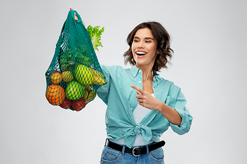 Image showing happy smiling woman with food in reusable net bag