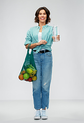 Image showing woman with bag for food shopping and glass bottle