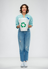 Image showing smiling young woman sorting plastic waste