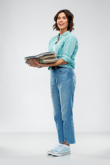 Image showing smiling young woman sorting paper waste