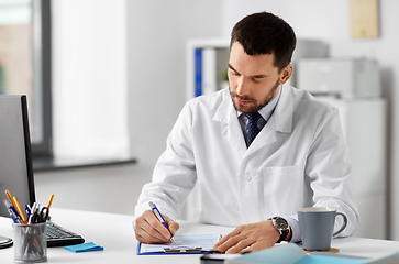 Image showing male doctor with clipboard at hospital