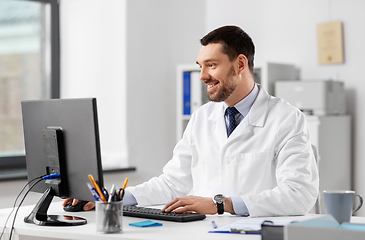 Image showing male doctor with computer working at hospital