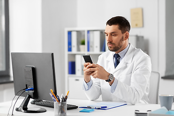 Image showing male doctor with smartphone at hospital