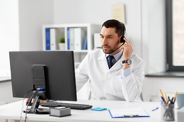 Image showing male doctor with computer and headset at hospital