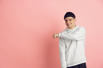 Image showing Caucasian young man\'s modern portrait on pink studio background