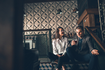 Image showing Cheerful man and woman talking, enjoying, having fun at bar, cafe