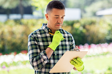 Image showing man with clipboard at summer garden