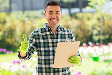 Image showing man with clipboard showing thumbs up at garden