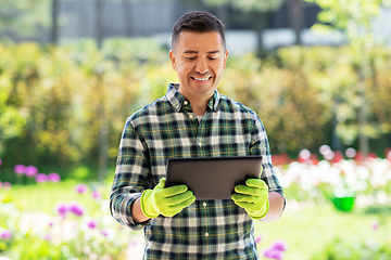 Image showing happy man with tablet pc at summer garden