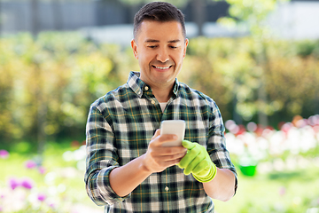 Image showing happy man with smartphone at summer garden