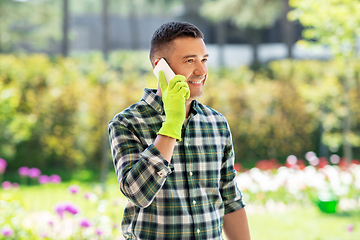 Image showing happy man calling on smartphone at summer garden