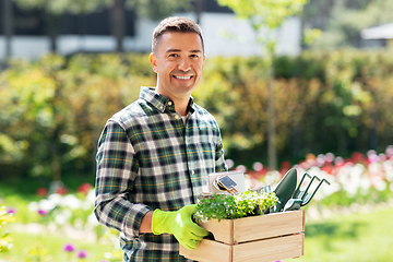 Image showing happy man with tools in box at summer garden