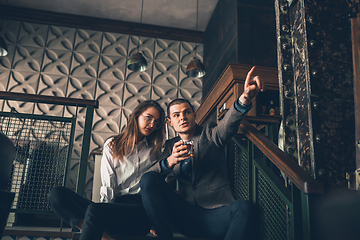 Image showing Cheerful man and woman talking, enjoying, having fun at bar, cafe